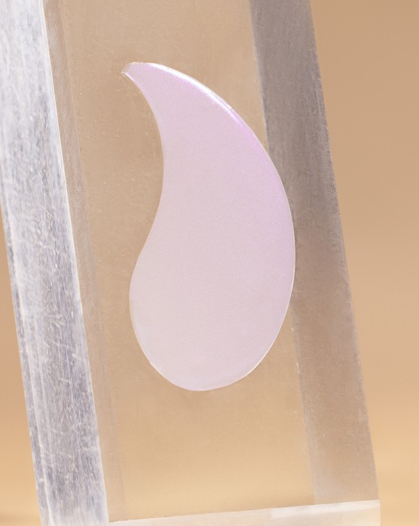 Close-up of a pearly pink Brighten Up under-eye patch